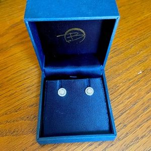 Two round brilliant cut diamonds prong-set in a halo style earring setting.